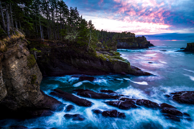 Long exposure coastal cliffs at Cape Flattery with fire clouds at sunset